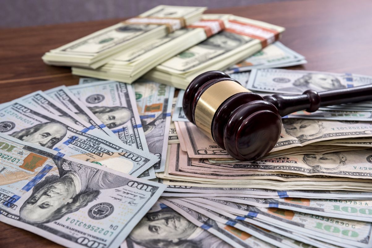 A gavel on top of a pile of money.