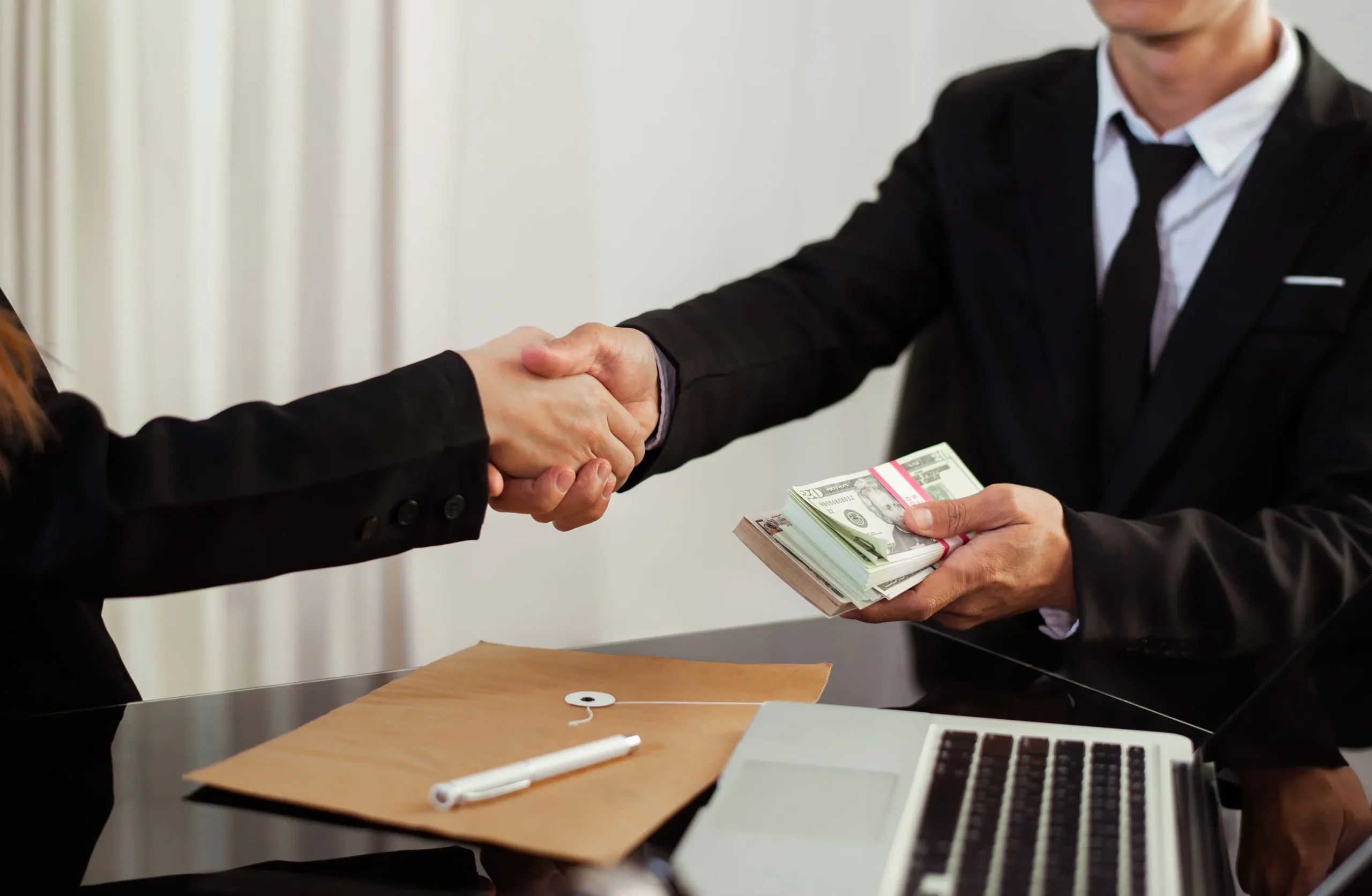 Business men exchanging money.