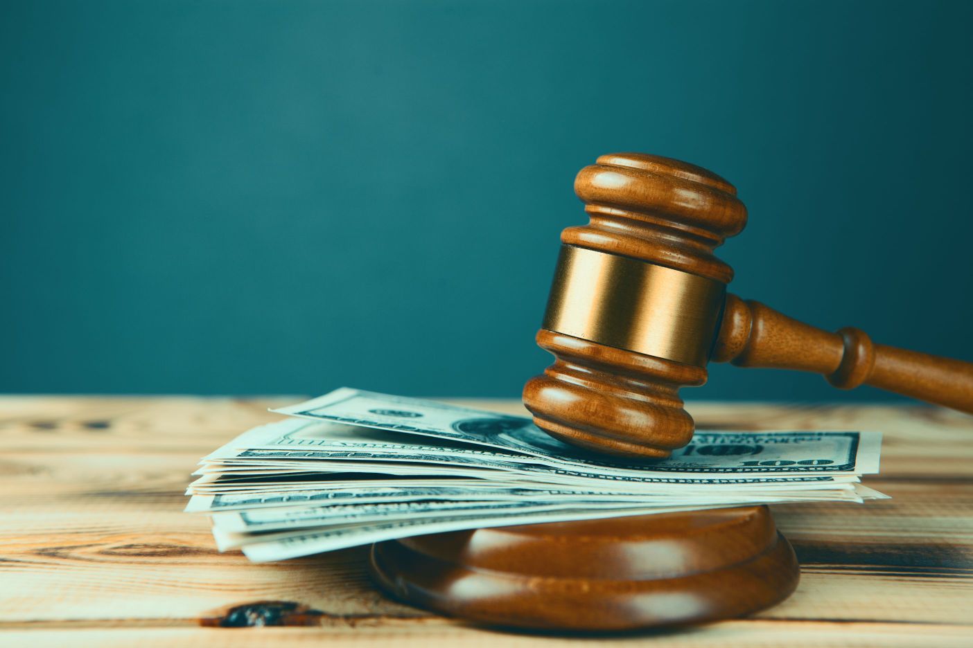 A gavel on top of a stack of money.