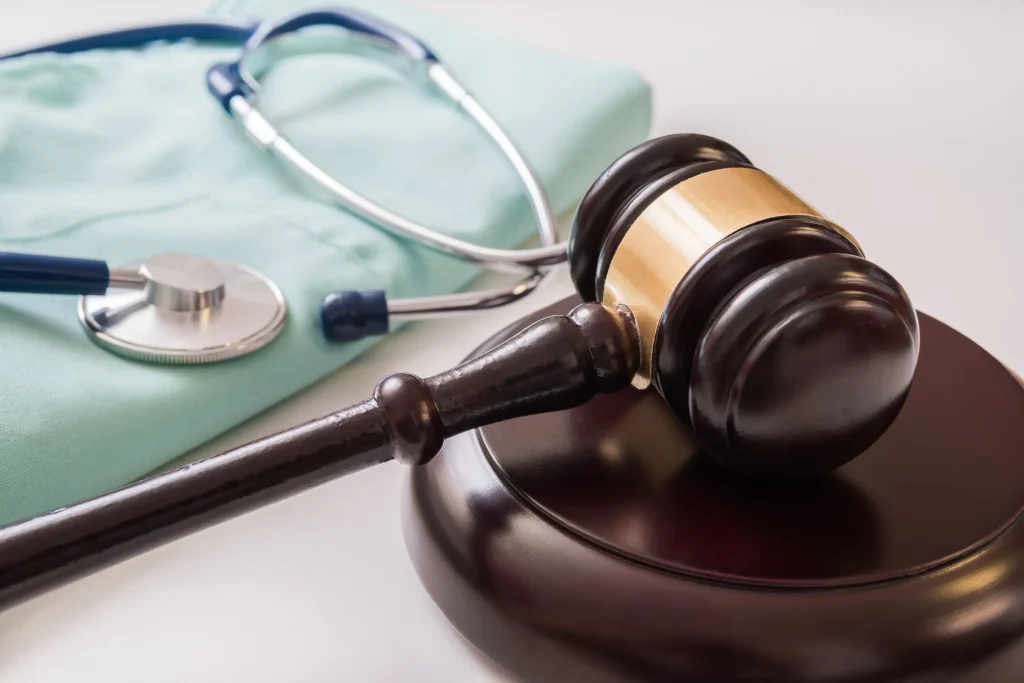 A gavel and stethoscope placed on a judge’s bench, symbolizing legal action related to healthcare fraud.